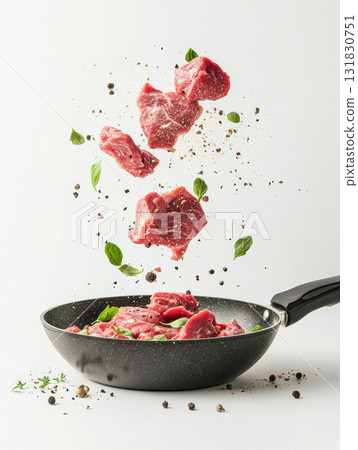 Dynamic pieces of fresh raw red meat with spices ingredient floating cooking with frying pan isolated on white background 131830751
