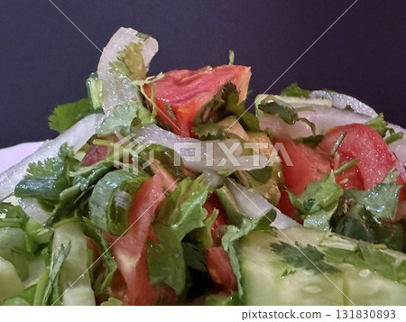 Macro shot of a salad with fresh vegetables and herbs. Freshly made Mediterranean salad on plate. Macro shot of a salad with fresh vegetables and herbs. Freshly made Mediterranean salad on plate. 131830893