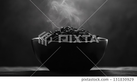 Black and white image of a bowl of black tea with smoke. Black and white image of a bowl of black tea with smoke. 131830929