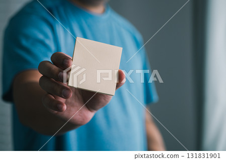 Creative hand with blank note indoor setting visual content simplistic view conceptual clarity Creative hand with blank note indoor setting visual content simplistic view conceptual clarity 131831901
