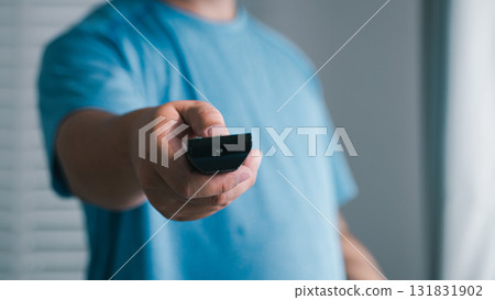 Handing over the remote a cozy indoor gesture home living room action shot warm environment 131831902