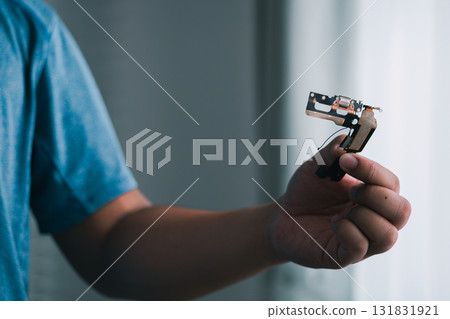 Handcrafted tech innovation ingenious handheld device creation at home close-up view creative process 131831921