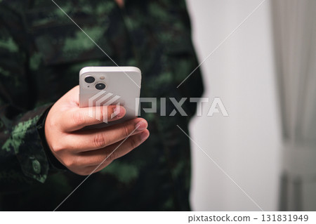 Military personnel using smartphone indoor setting candid shot modern communication close-up perspective Military personnel using smartphone indoor setting candid shot modern communication close-up perspective 131831949