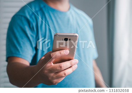 Capturing moments hand holding smartphone indoor setting mobile digital lifestyle close-up view 131832038