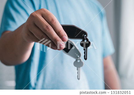 Hand holding keychain with keys indoor setting lifestyle shot personal touch close-up view everyday life Hand holding keychain with keys indoor setting lifestyle shot personal touch close-up view everyday life 131832051