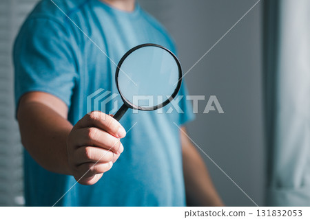 Investigating clarity handheld magnifying glass a modern room object focus indoor close-up view 131832053