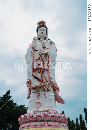 Majestic statue of guanyin serene garden peaceful environment low angle spiritual enlightenment 131832380