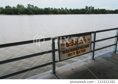 Riverside safety notice precaution against falling into water a calm environment Riverside safety notice precaution against falling into water a calm environment 131832382