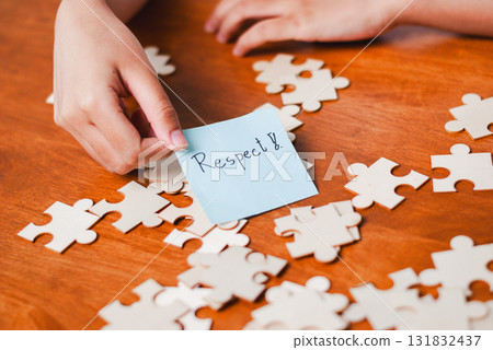 Promoting respect through puzzle pieces educational setting conceptual image warm atmosphere close-up focus Promoting respect through puzzle pieces educational setting conceptual image warm atmosphere close-up focus 131832437