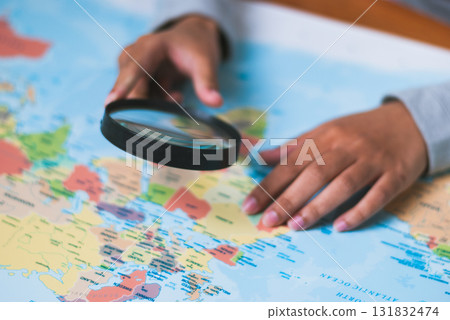 Exploring the world map hands- learning classroom educational environment close-up view geography concepts 131832474