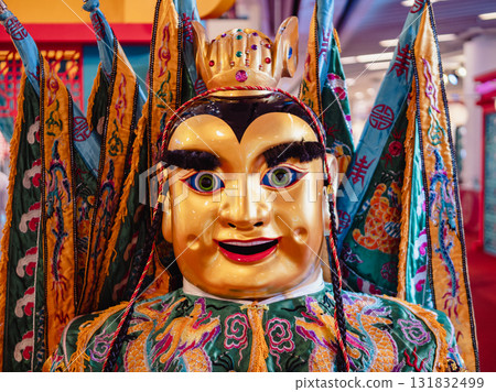 Cultural festival celebration featuring traditional masked performer urban setting close-up vibrant atmosphere Cultural festival celebration featuring traditional masked performer urban setting close-up vibrant atmosphere 131832499