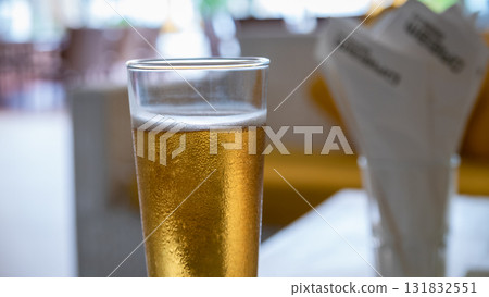 Refreshing beer served in a glass bar setting beverage indoor ambience close-up view Refreshing beer served in a glass bar setting beverage indoor ambience close-up view 131832551