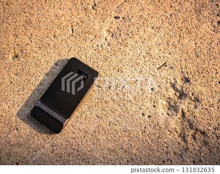 Smartphone abandoned sandy beach coastal scene outdoor natural light Smartphone abandoned sandy beach coastal scene outdoor natural light 131832635