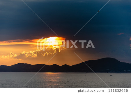 Dramatic sunset over mountain landscape ocean view serene nature scene tranquil evening 131832656