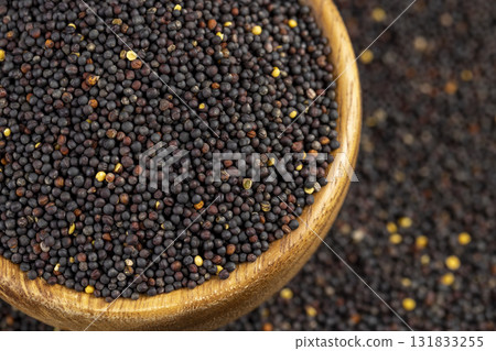 a large number of black rapeseed seeds are used to produce rapeseed oil, black rapeseed is used to produce food products, round wooden bowl filled with round rapeseed seeds a large number of black rapeseed seeds are used to produce rapeseed oil, black rapeseed is used to produce food products, round wooden bowl filled with round rapeseed seeds 131833255
