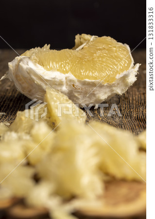 sliced yellow citrus, delicious fresh citrus on a wooden board, close up sliced yellow citrus, delicious fresh citrus on a wooden board, close up 131833316