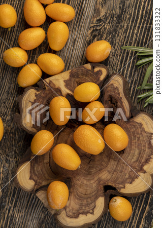 fresh and dried kumquat fruits on the table, fresh kumquats and dehydrated dried kumquats sprinkled with powdered sugar 131833322