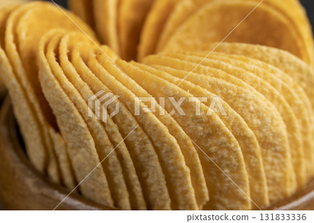 crispy potato chips fried in oil and sprinkled dried red pepper, a large number of delicious salty sweet pepper-flavored chips with aromatic spices crispy potato chips fried in oil and sprinkled dried red pepper, a large number of delicious salty sweet pepper-flavored chips with aromatic spices 131833336