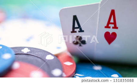 A poker player has two aces on the table. They have opened their cards and seen that they have two aces. This is a strong hand and it would be wise for them to continue playing and raise the stakes. A poker player has two aces on the table. They have opened their cards and seen that they have two aces. This is a strong hand and it would be wise for them to continue playing and raise the stakes. 131835088