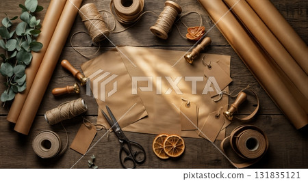 Artisan Christmas Gift Wrapping Workshop Station with Kraft Paper Rolls Natural Twine Vintage Scissors and Eucalyptus Sprigs on Reclaimed Barn Wood Surface Artisan Christmas Gift Wrapping Workshop Station with Kraft Paper Rolls Natural Twine Vintage Scissors and Eucalyptus Sprigs on Reclaimed Barn Wood Surface 131835121