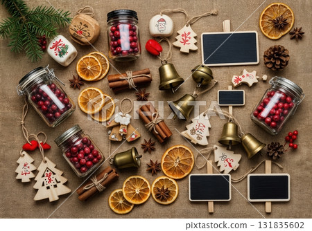 Rustic Christmas Market Flat Lay with Burlap Fabric Mason Jars Cranberries Wooden Ornaments and Vintage Brass Bells 131835602