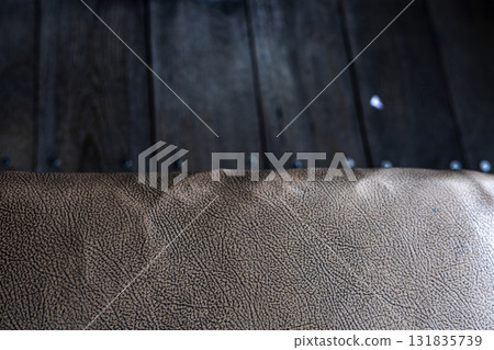 Old faux leather sheet on rustic wooden surface, detailed texture perfect for background photography, vintage advertising, design materials, and creative media projects. Old faux leather sheet on rustic wooden surface, detailed texture perfect for background photography, vintage advertising, design materials, and creative media projects. 131835739