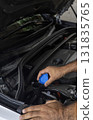 Auto mechanic working in garage 131835765