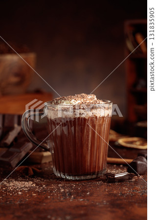 Hot chocolate topped with whipped cream and sprinkled with chocolate chips. 131835905