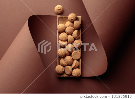 Chocolate truffles on a brown background. Chocolate truffles on a brown background. 131835913