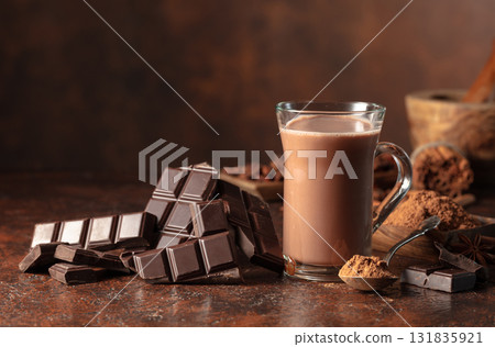 Pieces of bitter chocolate and glass of cocoa drink. Pieces of bitter chocolate and glass of cocoa drink. 131835921