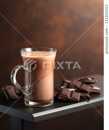 Pieces of chocolate and glass of cocoa drink. Pieces of chocolate and glass of cocoa drink. 131835922