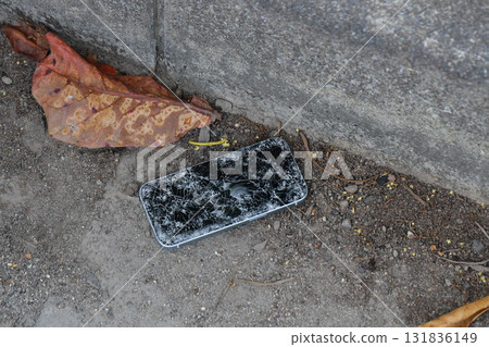 A broken smartphone dropped on the road 131836149