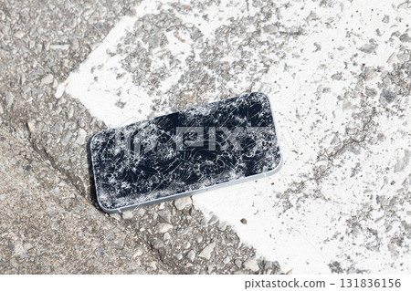A broken smartphone dropped on the road 131836156