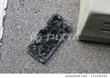 A broken smartphone dropped on the road 131836162