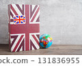 Bangkok, Thailand April 1, 2023 English book and piggy bank with globe, learning and tutorial for foreigner. 131836955