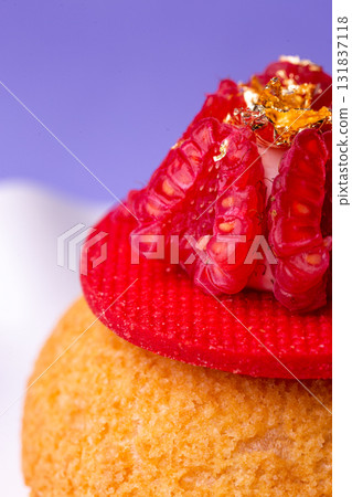 Macro of dessert with raspberry and gold - luxury, texture and bold colors on purple 131837118