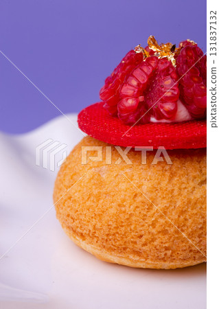 Macro of dessert with raspberry and gold - luxury, texture and bold colors on purple 131837132