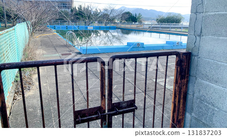 Abandoned school's dilapidated swimming pool 131837203