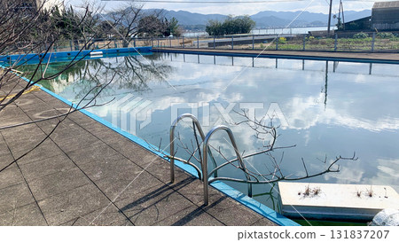 Abandoned school's dilapidated swimming pool 131837207