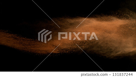 Flying orange clay dust in motion, isolated on black background. High-speed studio photo with dramatic particles explosion. Tennis-themed abstract powder movement. Flying orange clay dust in motion, isolated on black background. High-speed studio photo with dramatic particles explosion. Tennis-themed abstract powder movement. 131837244