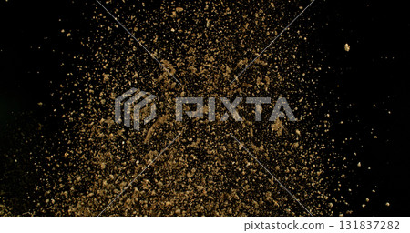 Detailed wave of airborne clay dust swirling in chaotic motion, captured in freeze  motion. Dramatic natural explosion of earthy particles on black background. 131837282