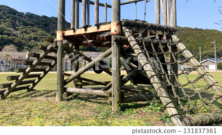 A wooden jungle gym remains at an abandoned school 131837361