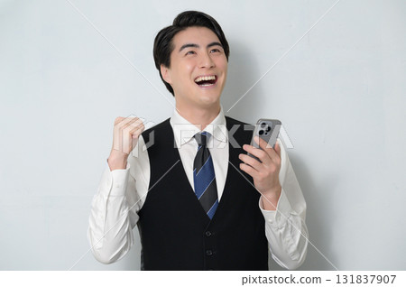 A man who is pleased to see a smartphone A man who is pleased to see a smartphone 131837907