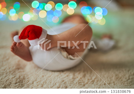 Close-up shot of a newborn baby lying on its back with its tiny feet in the air, one of which has a Close-up shot of a newborn baby lying on its back with its tiny feet in the air, one of which has a 131838676