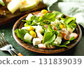 Fresh arugula salad with prosciutto, melon, and olives for a delicious summer meal 131839039