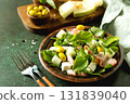 Fresh arugula salad with prosciutto, melon, and olives for a delicious summer meal. Copy space. 131839040
