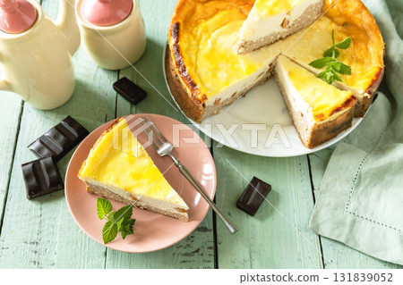 Delicious lemon cheesecake with tea set for dessert presentation. Delicious lemon cheesecake with tea set for dessert presentation. 131839052