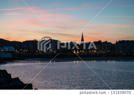 Resort hotels lined up along Concha Beach in San Sebastian and the street lights in the morning glow 131839070