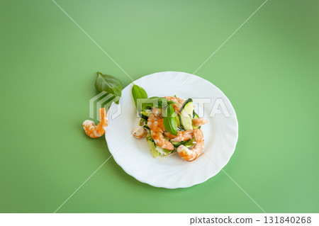 Light salad with seafood on a green background Light salad with seafood on a green background 131840268