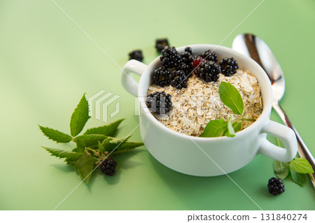 Vegan porridge with berries in a white bowl Vegan porridge with berries in a white bowl 131840274